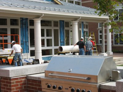 Setting up columns on the porch outside Frank's Lounge. (Doug Hubley/Bates College)