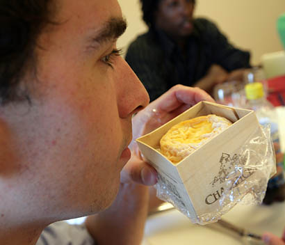 Josh Parker '08 of Winchester, Mass., a student in the Short Term course "Food, Culture and Performance," inhales the aroma of Langres, a French cheese. 