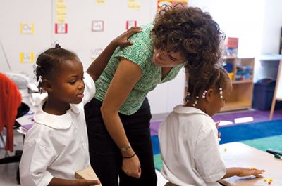 Margaret "Meg" Kinney '08, is a Teach for America teacher in her second year of service but in her first year of teaching at the Benjamin E. Mays Preparatory School, a charter school located in a trailer in the Carver School in the ninth ward of New Orleans, an area largely destroyed by Hurricane Katrina. Photographed in her classroom, she is alternately alone, with Sarah "Morgan" Carter '03, and with her students, in grades K-2. Each Mays Prep classroom is named after a college (college aspirations being a huge mission of the school) and Meg's classroom is named "Bates College."