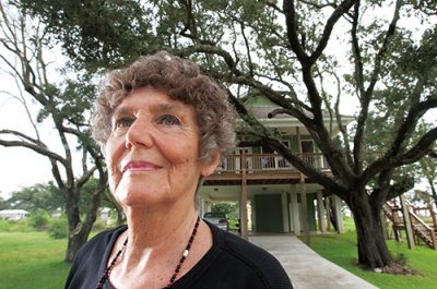 Janet C. Millard '54 of Long Beach, Miss., poses by the beach and at her home at 419 Gulf View Ave. She rebuilt the home after it was destroyed by Hurricane Katrina in 2005. Millard said that her love for the live oak trees on her property and the water adjacent to it were two of the major reasons she decided to rebuild.