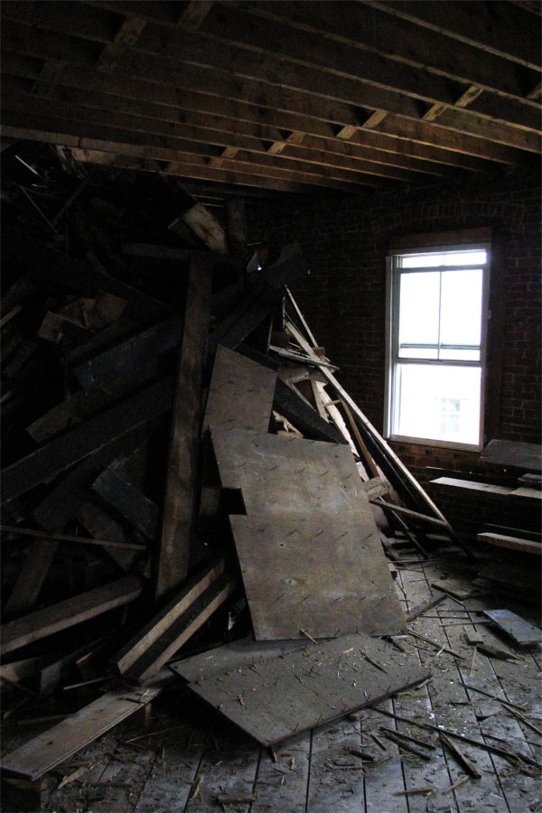 If these walls could talk, they'd say "ouch": Scrap wood in a heap during the gutting of Roger Williams Hall. (Doug Hubley/Bates College)