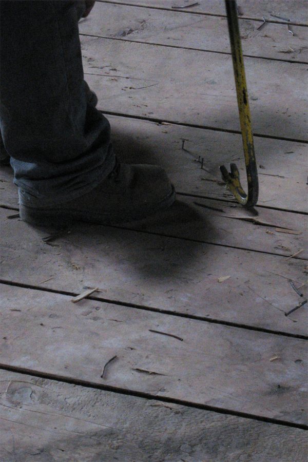 Pulling nails out of a Roger Williams Hall floor in May 2010. (Doug Hubley/Bates College)