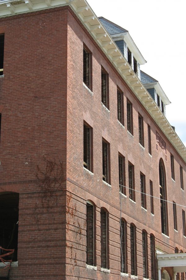 With the interior largely gutted and black holes where the windows used to be, Roger Williams Hall is a ghostly shell. (Doug Hiubley/Bates College)