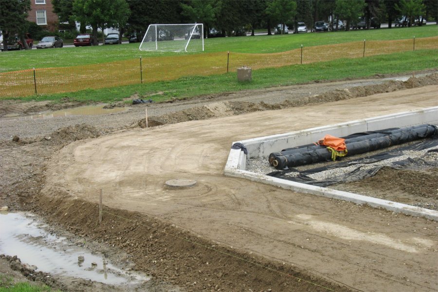 Round the bend: The bed for a future walkway and the concrete anchor curb mark a corner of Garcelon Field. (Doug Hubley/Bates College)