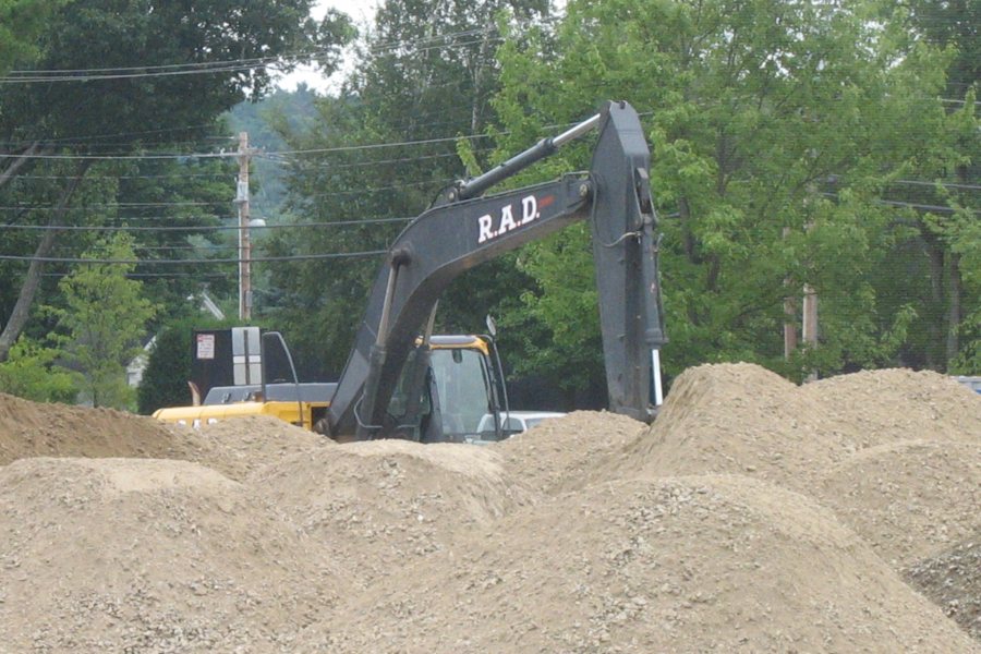 A power shovel appears to be nearly concealed by mounds of crushed rock on Garcelon Field. (Doug Hubley/Bates College)