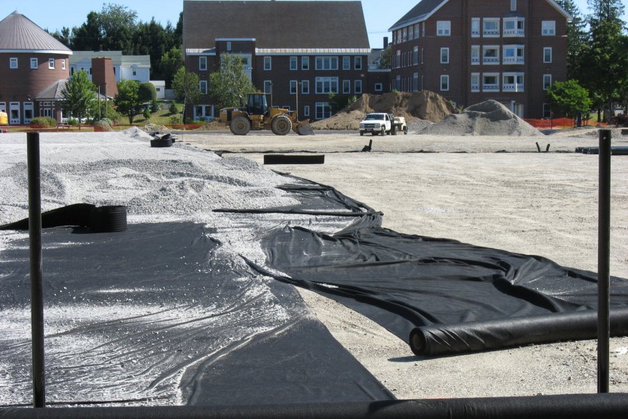 Geotextile is rolled out to stabilize the layers of substrate, and then covered with crushed stone. (Doug Hubley/Bates College)