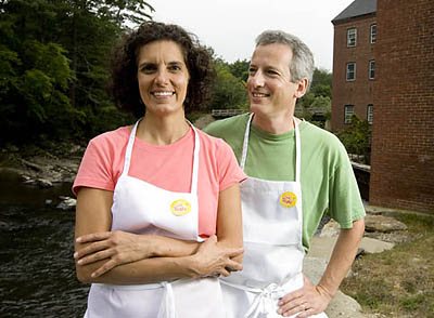 Beth George '85 and Tim Kane '85 outside and inside of their family-owned company, Spelt Right, Inc., located in Yarmouth's Sparhawk Mill at 81Bridge Street, overlooking the Royal River. The river powers the mill.
Spelt Right® is a small family owned Maine company that specializes in baked goods made with organic spelt flour and other organic and all natural ingredients. We started Spelt Right in 2007 as a result of our discovery that our young son was sensitive to common wheat (triticum aestivum). In our search for alternative great tasting, healthy grains that he could enjoy, we found spelt (triticum spelta), an ancient cousin of common wheat. Unable to find âkid friendlyâ spelt products in the market place, we decided to make them ourselves.
In June 2008, we moved our facility to the historic and green Sparhawk Mill (the bakery is powered by water from the Royal River) in beautiful Yarmouth, Maine expanding our capacity to meet our growing sales to health and specialty food stores, supermarkets, local restaurants, educational institutions, and to people like you! If you are in the area and would like to visit the facility, please call us for a scheduled tour.