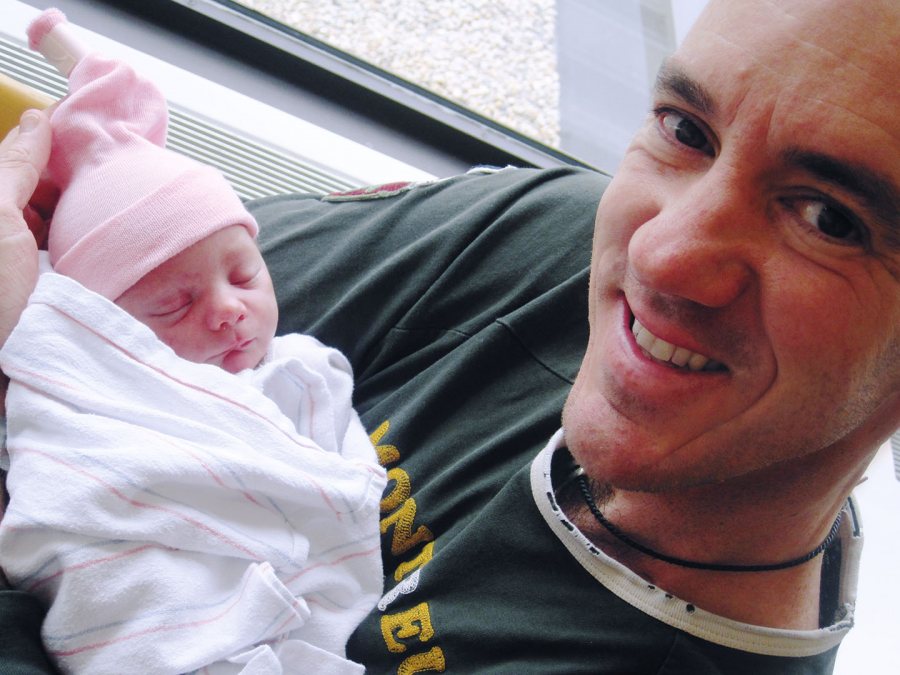     Mercer holds his daughter, Rachel Maria Sechi Mercer, after her birth on Aug. 14, 2010.