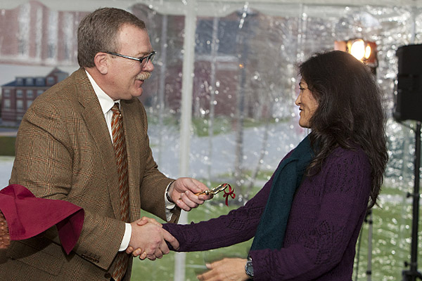 Board chair Mike Bonney '80 presents a symbolic key to Roger Williams Hall to Spanish professor Claudia Aburto Guzmán during dedication festivities for Roger Williams and Hedge halls. Photograph by Rene Minnis.