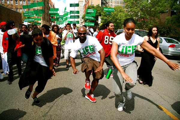 Marc Bamuthi Joseph, shown at center during the "Life is Living" festival, Chicago, 2009. Photo by Bethanie Hines.