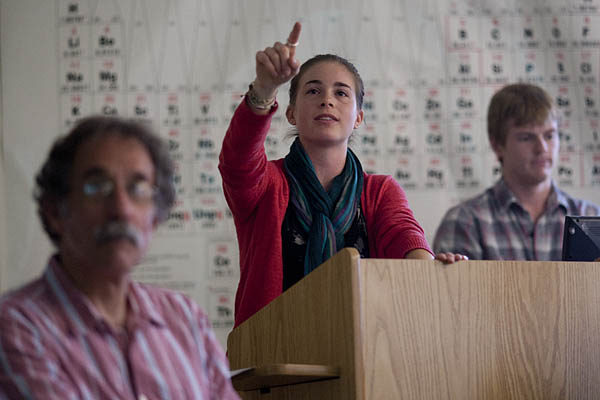 As professor Tom Wenzel, at left, and Bradley Gee '12  look on, Gwynneth Johnson '12 makes a point about the Lisbon trail signage plan.