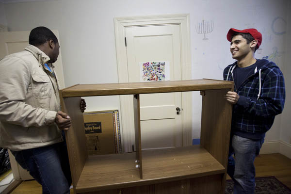 This October 2010 image shows Mikey Pasek '12, right, with Jourdan Fanning '13, left moving furniture in the Office of Intercultural Education, a location that includes space for Bates Hillel. Photograph by Phyllis Graber Jensen/Bates College.