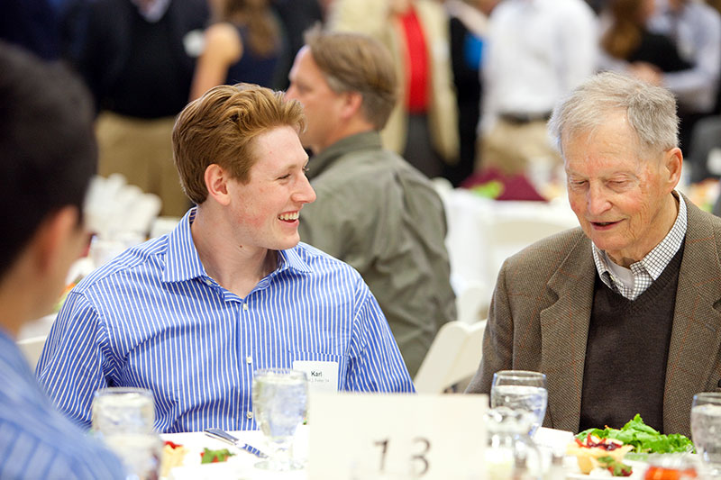 Karl Fisher '14, left, talks with Charles E. Clark '51 at the Mount David Society Scholarship Luncheon on March 30. Clark is the author of Bates Through the Years: An Illustrated History, as part of the college's sesquicentennial.