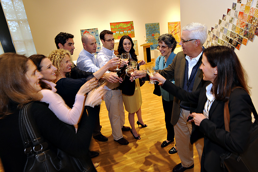 Family and friends toast Bruce Stangle '70 (second from right) and Emily Siegel Stangle '72 (third from right) on the occasion of his being the first recipient of a new Alumni Association award named in his honor: the Bruce Stangle Award for Distinguished Service to the Bates Community. Photograph by Jose Leiva. 