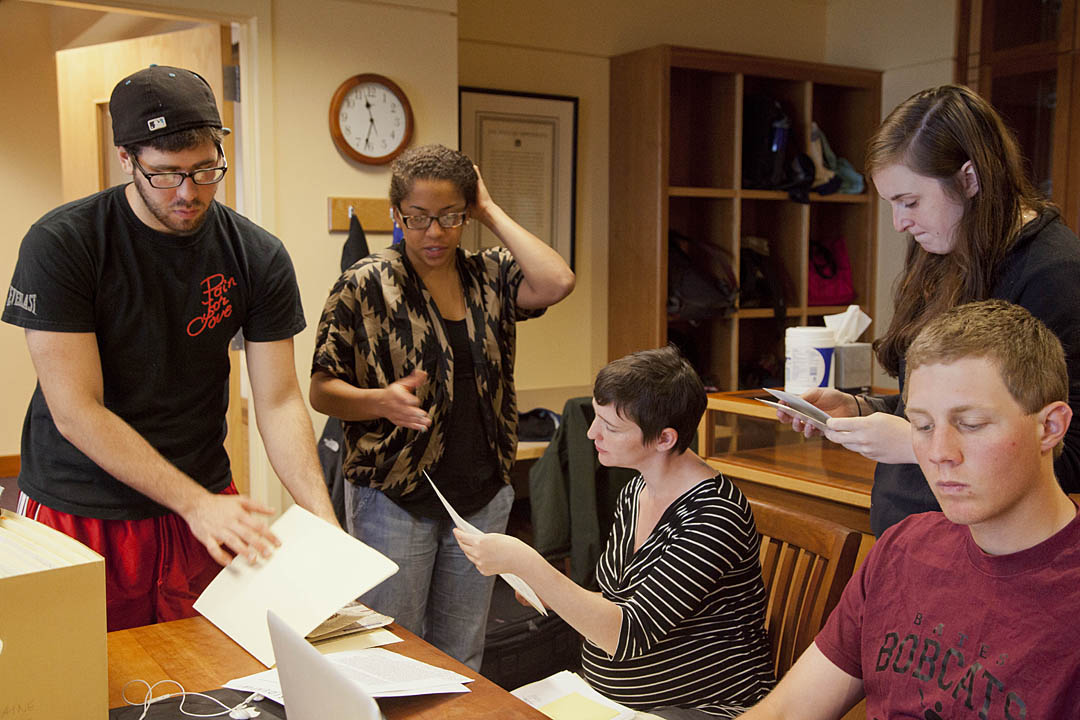 Students in the Short Term course "Making African American History: Preserving the Archives of the Portland NAACP" examine documents during a work session at the University of Southern Maine. From left: Joncarl Hersey '12, Tasheana Dukuly '12, professor Mollie Godfrey, Munroe Graham '13, Brad Reynolds '14. Photograph by Phyllis Graber Jensen/Bates College.