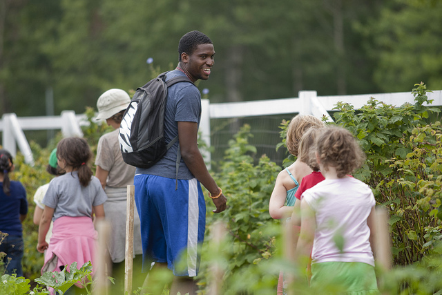 Among the Harward Center's initiatives is the Community-Based Research program, which allows students to connect service and academics. Above, David Longdon '13 helps lead youth programming with Lots to Gardens, a community garden program in Lewiston. Photograph by Phyllis Graber Jensen/Bates College