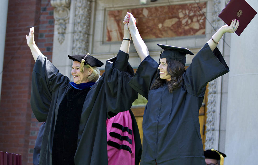 With characteristic charm and sense of the moment, interim President Nancy Cable salutes Hannah Zweifler, the final graduate to receive her diploma at Commencement 2012. Photograph by Phyllis Graber Jensen / Bates College.