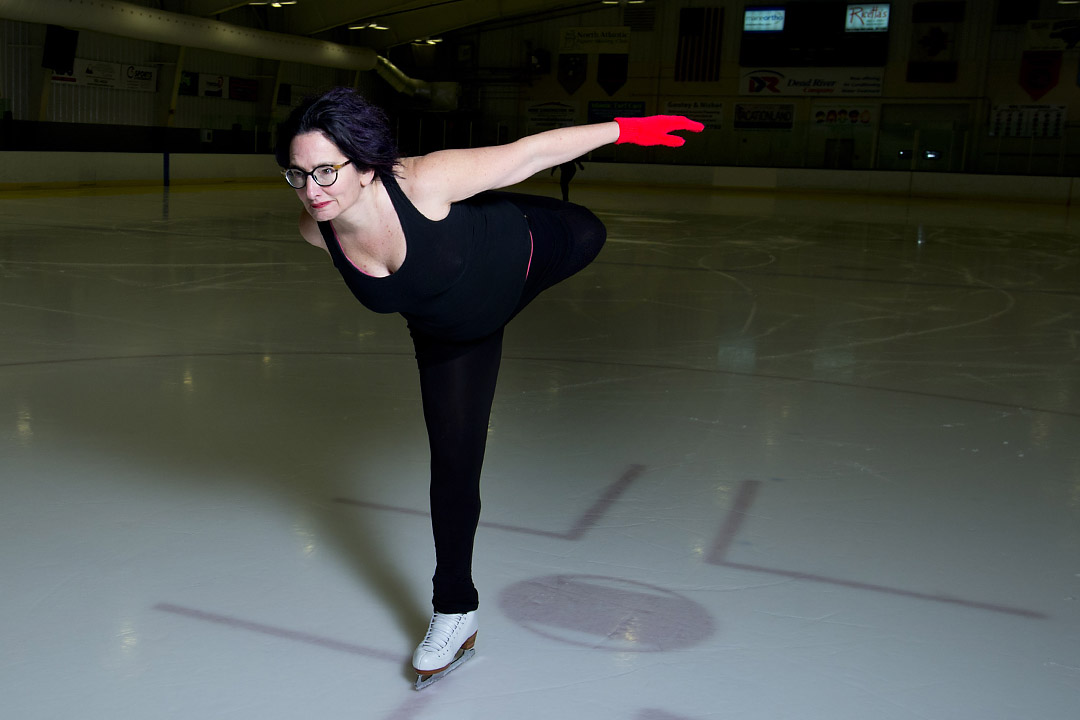 A participant as well as scholar of culture, Rand often injects personal experiences into her work. Here, skating in Falmouth, she bends back her leg for a catch-foot spiral, an "age-defying" move she describes in Red Nails, Black Skates. Photograph by Mike Bradley/Bates College.