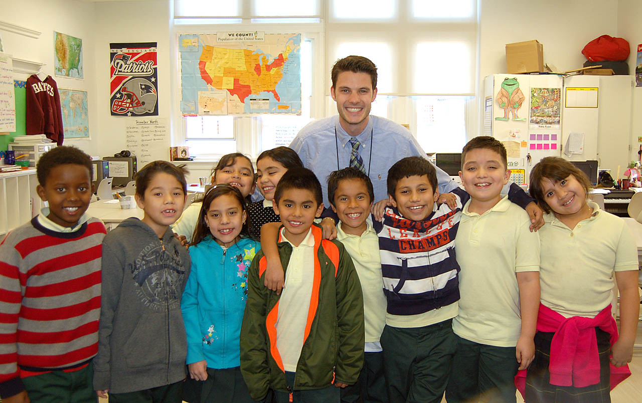 All smiles, Drew Gallagher '11 poses with a group of his students at Bruce-Monroe Elementary School in Washington, D.C. Photo courtesy of Drew Gallagher '11.