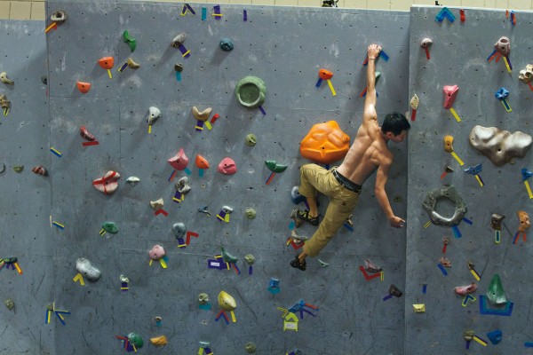 Chester Chiao '13 trains on the rock wall in Merill Gymnasium Photograph by Phyllis Graber Jensen/Bates College
