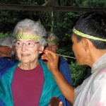 Author and world traveler Dorothy Stetson Conlon ’50 has her face painted by a shaman in the Amazon jungle of Ecuador in 2009. 