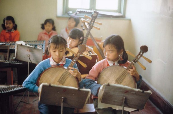 Children in a classroom wear brightly colored sweaters, a sign of new socioeconomic forces at play. Photograph by Steve Stone '83.