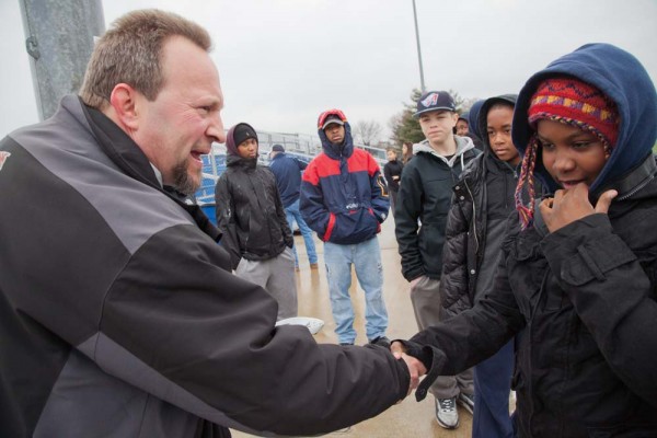 Bates head coach Peter Lasagna greets young boys and girls from Metro Lacrosse, the Boston nonprofit that focuses on youth development and education through lacrosse competition and receives support from Morgan’s Fund. Photograph by Phyllis Graber Jensen/Bates 