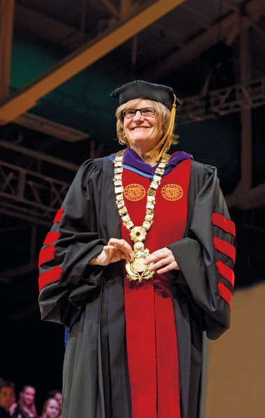 Clayton Spencer shows off the presidential collar following her installation as the college’s eighth president. Photograph by Mike Bradley