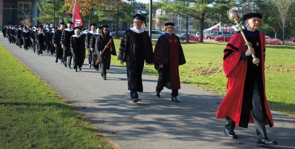 Mace bearer Sawyer Sylvester, professor of sociology, leads the academic procession to Merrill Gymnasium on Oct. 26, 2012. Photograph by Mike Bradley