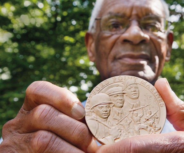 Shown at his Manchester Center, Vt., home in September 2012, Nathaniel Boone ’52 displays the Congressional Gold Medal he received for his service as a Montford Point Marine. Photograph by Phyllis Graber Jensen/Bates College