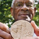 Shown at his Manchester Center, Vt., home in September 2012, Nathaniel Boone ’52 displays the Congressional Gold Medal he received for his service as a Montford Point Marine.  Photograph by Phyllis Graber Jensen