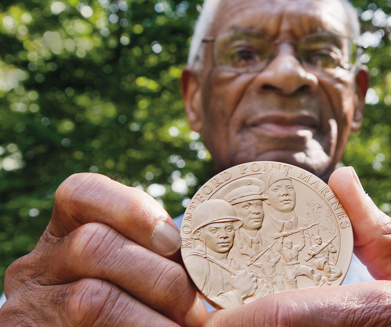 Shown at his Manchester Center, Vt., home in September 2012, Nathaniel Boone ’52 displays the Congressional Gold Medal he received for his service as a Montford Point Marine. 
Photograph by Phyllis Graber Jensen