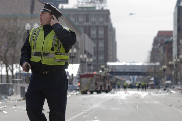 A Boston police officer shouts instructions on Boylston Street in Boston on April 15, 2013. Photograph by Bates photographer Mike Bradley, who was at the marathon earlier in the day and returned to cover the aftermath for a New York City media outlet.