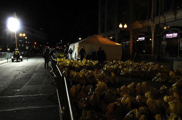 Bags that were left unclaimed by marathoners are collected on Berkeley Street in Boston on April 15, 2013. Three people were killed by two explosions on Boylston Street near the finish line of the Boston Marathon, in which 27,000 people competed.