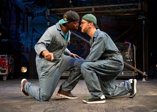 Postell Pringle '98 (left, as Othello) and GQ (Iago) face off as Iago’s plot unfolds in Chicago Shakespeare Theater’s production of Othello: The Remix. Photograph by Michael Brosilow. 