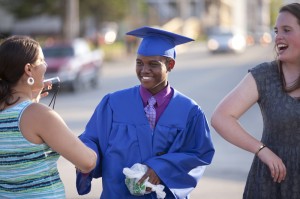 Tree Street Youth places a strong emphasis on academic achievement. Here Sleeper, left, congratulates a student upon his graduation from Lewiston High School as Sullivan, right, looks on. Photo by Phyllis Graber Jensen/Bates College.