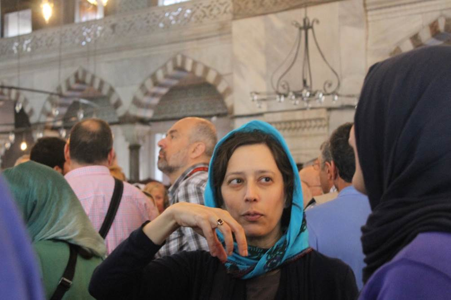 Bates Assistant Professor of Politics Senem Aslan explains aspects of the structure of the building to a student in a mosque crowded by tourists. Phillip Dube '16/Bates College.