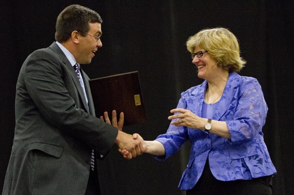 Brad Adams '92 is congratulated by President Clayton Spencer as he receives the Stangle Award for Distinguished Service to the Bates Community on June 8, 2013, at Reunion. Photograph by Phyllis Graber Jensen/Bates College.