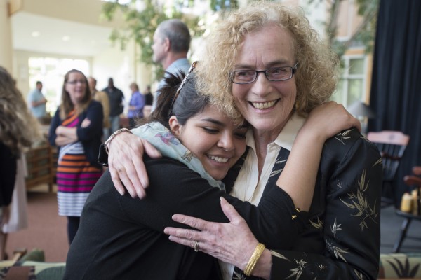 Pam Baker hugs a student during a reception for Baker's retirement on May 17, 2013. (Mike Bradley/Bates College)