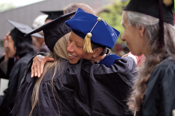 Politics professor Leslie Hill hugs a graduate after the ceremony. Photograph by Phyllis Graber Jensen