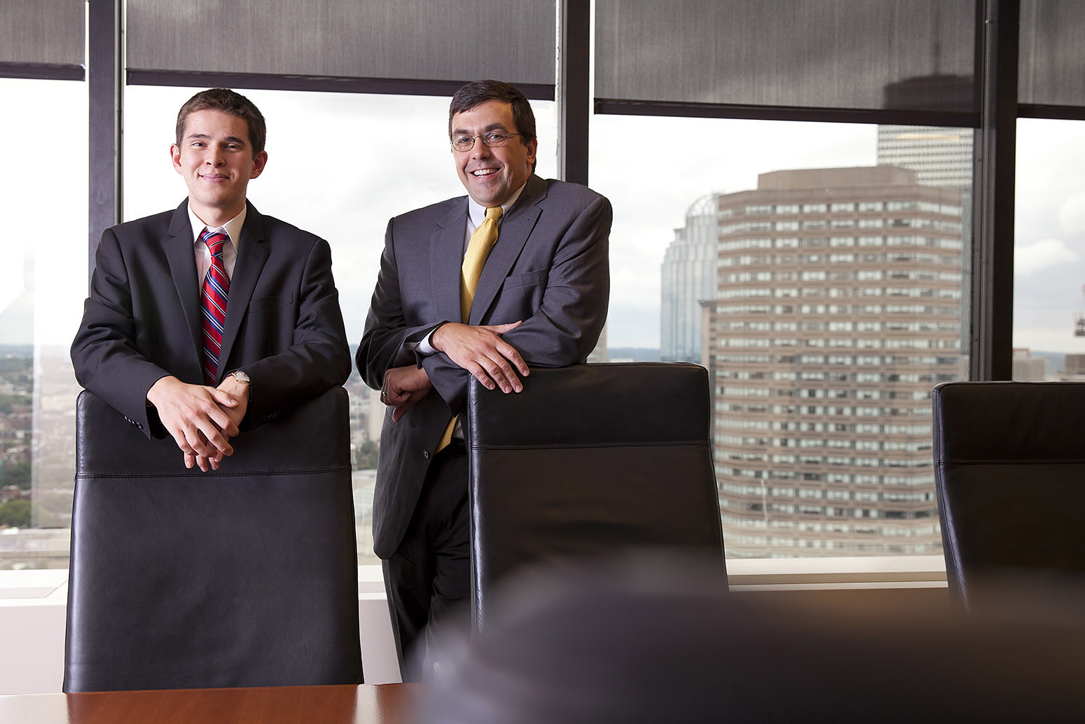 Ladd intern Zach Polich '15 and TM Capital managing director Brad Adams '92 pose at TM headquarters in Boston, located on the 25th floor of Hancock Place. (Phyllis Graber Jensen/Bates College)
