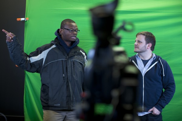 Joshua Ajamu ’14, a rhetoric major from Breinigsville, Pa., helps Colin Kelley set up a new multimedia studio in Pettigrew. Ajamu is president of the Bates College Television Network, and Kelley is a digital medial specialist. (Phyllis Graber Jensen/Bates College)