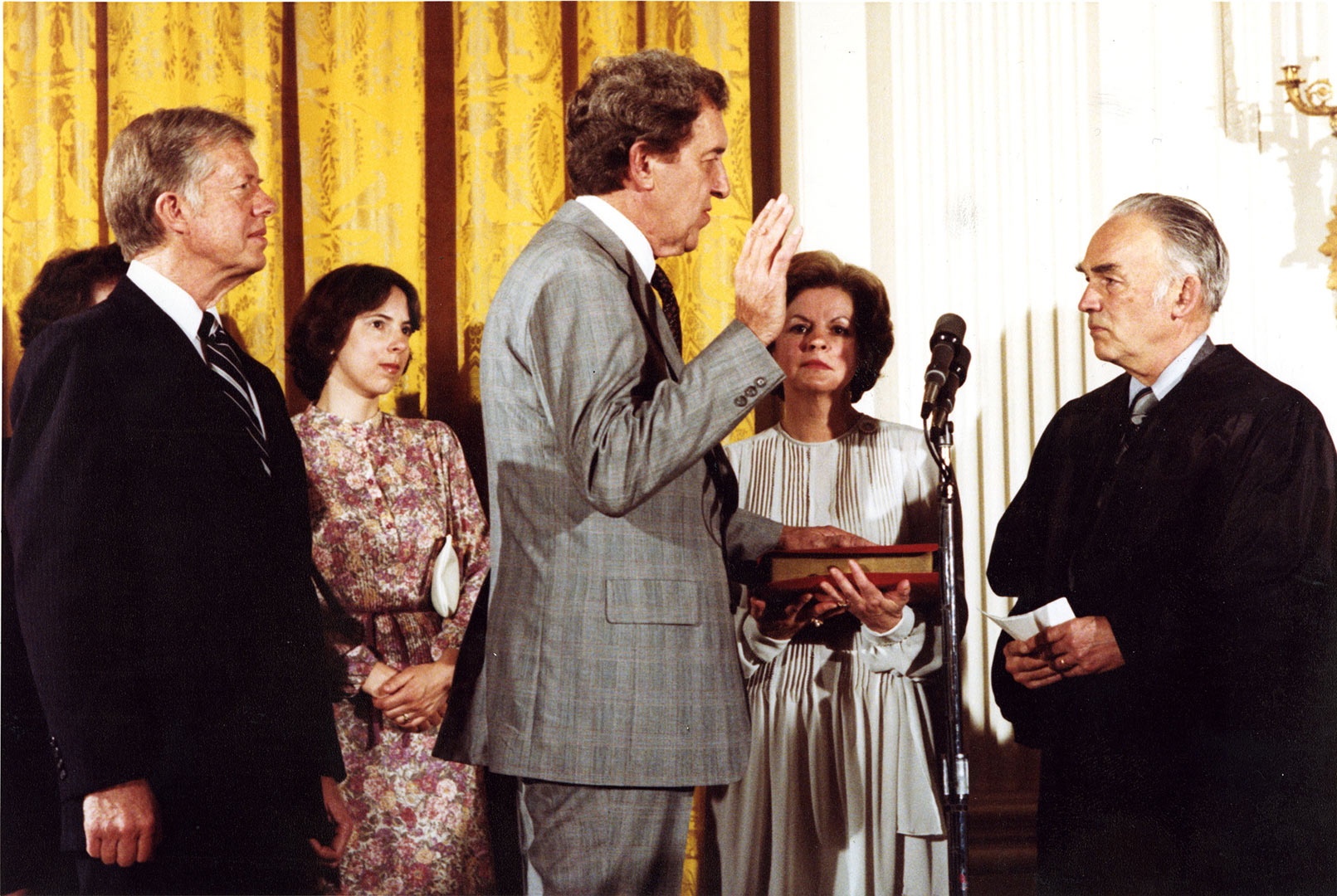 Edmund Muskie '36 is sworn in as U.S. secretary of state by longtime friend and adviser Frank Coffin '40, a federal judge at the time. Looking on are, from left, President Jimmy Carter; Muskie's daughter Ellen Muskie Allen; and his wife, Jane Muskie.