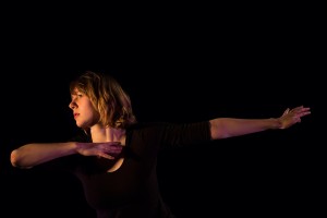 On the Schaeffer Theatre stage, Katie Ailes '14 performs "Homing," a work she choreographed for her senior thesis in dance. (Phyllis Graber Jensen/Bates College)