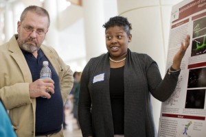 Jeff Sturgis '69, left, listens as Destany Franklin '14 discusses her neuroscience research during the 2014 Mount David Summit. (Phyllis Graber Jensen/Bates College)