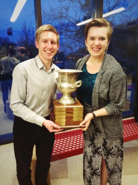 Jac Stewart (left) and Taylor Blackburn brandish the trophy for winning the U.S. Universities Debating Championship. 