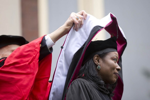 Isabel Wilkerson receives her honorary degree hood from Professor of Sociology Sawyer Sylvester. (Phyllis Graber Jensen/Bates College)