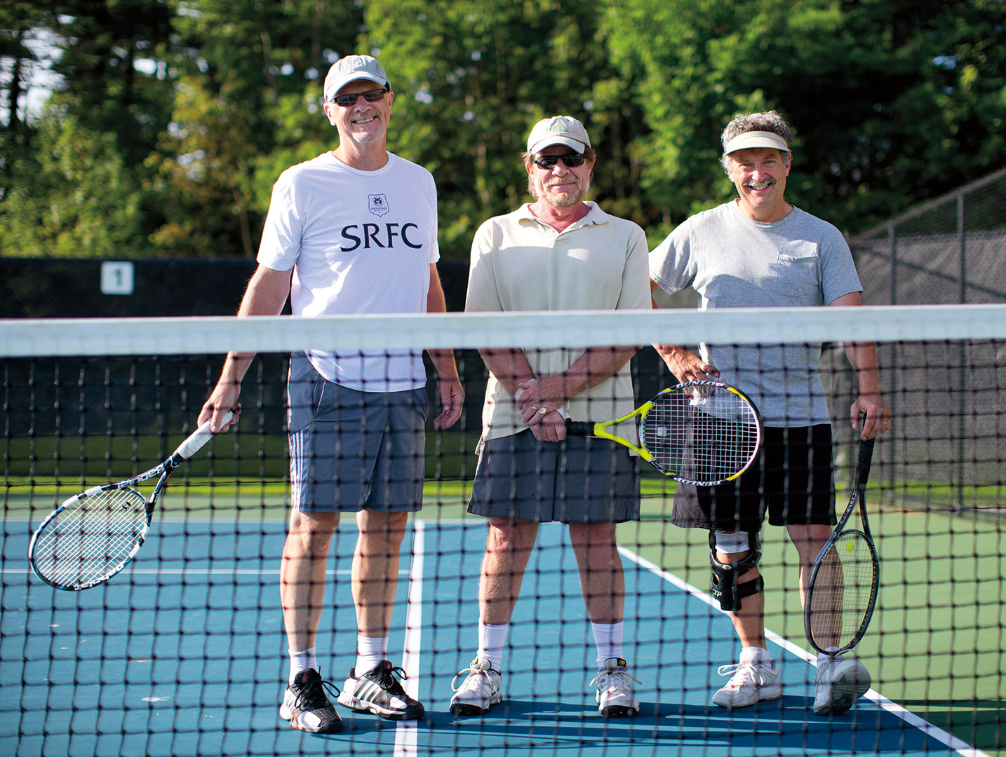 Professors Dennis Browne, Rob Farnsworth and Chip Ross deliver a few verbal volleys as they change sides. (The photographer was their fourth.) Photograph by Phyllis Graber Jensen