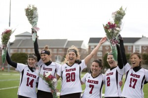 Lacrosse seniors give a cheer during a ceremony honoring seniors prior to the Bobcats’ final home game. (Phyllis Graber Jensen/Bates College)