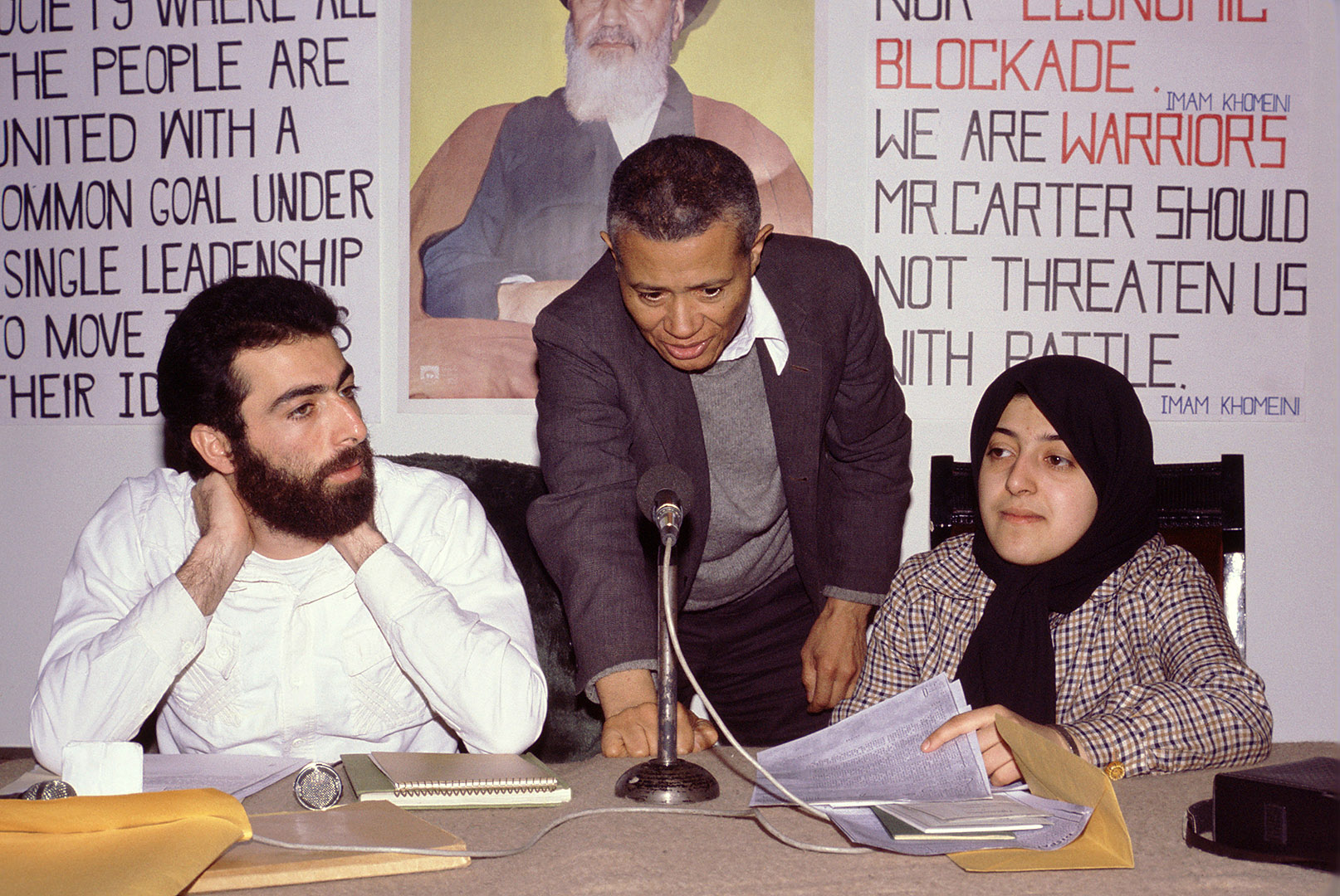 Image likely taken on Feb. 13, 1980 in Tehran, Iran. William Worthy '42 (center) setting up a question-answer session at a Tehran hotel with Hossein Sheikholislam (left) and Massoumeh Ebtekar (right), spokespeople for the students who held 52 U.S. diplomats hostage for 444 days. Ebtekar, often interviewed by U.S. journalists during the crisis, was dubbed "Screaming Mary" by the media. Now a professor of immunology in Tehran, she talked to Matt Lauer of the Today Show last September about the status of women in her country. Sheikholislam, meanwhile, became Iran's deputy foreign minister and ambassador to Syria. In February 2008 he received the Louis M. Lyons Award for Conscience and Integrity in Journalism from Harvard's Nieman Foundation for Journalism.